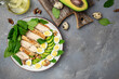 Ketogenic diet food, chicken fillet, quail eggs, avocado, spinach, walnut. healthy meal concept on a light background, banner, menu, recipe place for text, top view