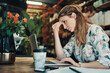 © Allistair/peopleimages.com - This is too much. Cropped shot of an attractive young businesswoman sitting alone in her floristry and feeling stressed while using her laptop.