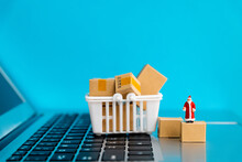 Santa Claus Figurine And Boxes On Laptop Keyboard