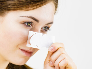 Wall Mural - Woman applying pore strips on nose