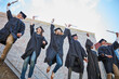 Graduation is a cause for celebration. Low angle shot of a happy group of students jumping in celebration on graduation day.