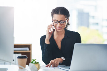 Sticker - Calling up clients to keep them well informed. Shot of a young businesswoman talking on a cellphone while working in an office.