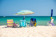 © parkerspics - Beach chairs and umbrella, located on a beach in the Mediterranean, on a  bright sunny, summer's day