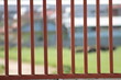 Rusty iron railing of prison with blurred nature background. End of the road, no more way concept. Metaphoric or analogical expression of the opposition between freedom and captivity. 
