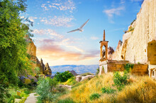 Observation Tower In Rock Monastery Of Zelve Valley And Seagull In Sky