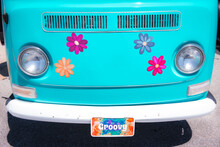 Front Of Turquoise Van With Colorful Daisy Flowers