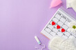 Top view photo of red heart marks on the calendar pink menstrual cup period pads tampon and camomile bud on isolated pastel violet background with copyspace