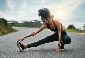 Sticker - Stretching is just as important as exercise. Full length shot of an attractive young sportswoman warming up for a workout outdoors.