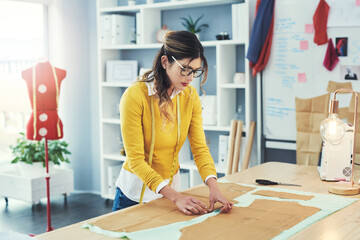 Poster - Preparation is the key to success. Cropped shot of an attractive young fashion designer in her workshop.