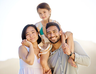 She is our pride and joy. Cropped shot of a happy diverse family of three at the beach.