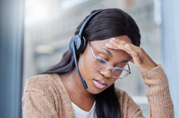 Sticker - This migraine is killing me. Shot of a businesswoman suffering with a migraine at her desk in her office.