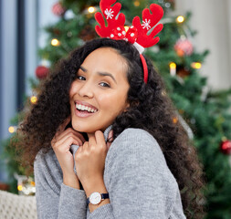 Poster - Comfy for Christmas. Shot of a young woman celebrating Christmas at home.