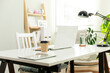 © dragonstock - The cosy workplace of a businesswoman working from home.