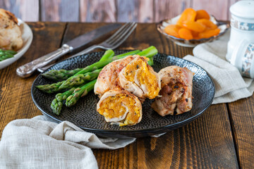 Canvas Print - Chicken thighs with appricot stuffing and asparagus