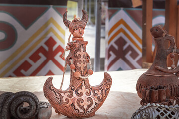 Wall Mural - Traditional Kazakh clay flask for drinks with a national ornament is sold on a street stall. Close-up