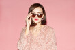 © Sergey Chumakov - young woman with sunglasses in pink dress isolated on pink background