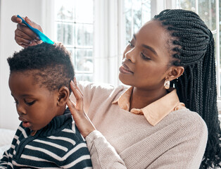 Sticker - Let mommy help you. Cropped shot of an attractive young woman combing her sons hair while sitting on a bed at home.