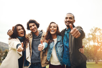 Aufkleber - What a great day to spend with friends. Portrait of a group of cheerful young friends huddled together while showing thumbs up outside during the day.