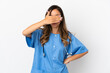 Young surgeon doctor woman over isolated white wall covering eyes by hands. Do not want to see something