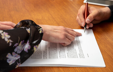 Agreement, business contract paper for signature. Woman and man hand on an office table, close up