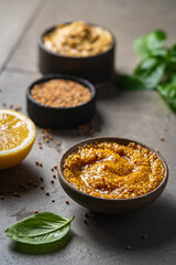 Poster - Fresh homemade organic dijon mustard in a bowl on gray background, close up