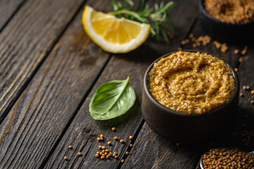 Poster - Fresh homemade organic dijon mustard in a bowl on wooden background, close up