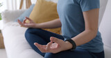 Fototapeta  - Close-up asia serene people asana sit rest deep calm in zen body fresh in lady peace life at cozy indoor home sofa. Girl enjoy hobby in good time warm praying pose for mental relax inhale happy sport.