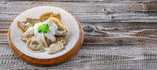 Composition With A Plate Of Classic Pierogies With Sour Cream