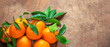 Mandarin oranges fruits or tangerines with leaves on a wooden table. Copyspace. Fresh picked mandarins Top view. Wallpaper