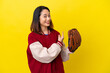 Young Vietnamese player woman with baseball glove isolated on yellow background pointing back