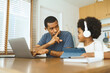 © eggeeggjiew - Black african american father silencing his Little son while online meeting on laptop, Working at home.