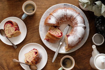 Sticker - Raspberry roll wreath. Brioche. Top view, wooden background, coffee, powdered sugar, yeast buns. 