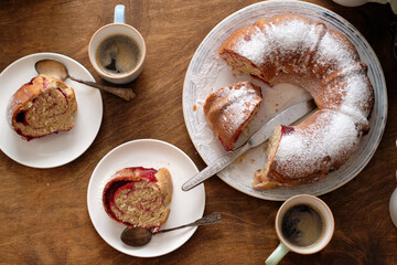 Wall Mural - Raspberry roll wreath. Brioche. Top view, wooden background, coffee, powdered sugar, yeast buns. 