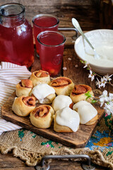 Sticker - Buns with cinnamon and cream sauce. cherry compote. side view.