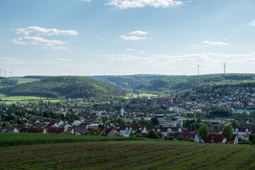 Wall Mural - Cityscape from the German town Tauberbischofsheim by day with wind wheels in the background.