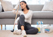 © Jade Maas/peopleimages.com - Im so tired. Shot of a young woman cleaning at home.