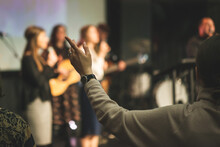 Hands In The Air Of A Woman Who Praise God At Church Service
