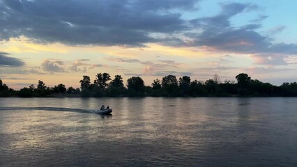 Canvas Print - River at sunset with a sailing boat