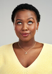 Poster - I love my natural hair. Shot of a young woman looking up while standing against a grey background.