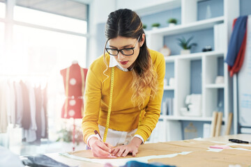 Poster - She designed a life she loved. Cropped shot of an attractive young fashion designer in her workshop.