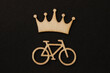 Wooden symbols, blocks on the black background bicycle and crown