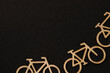 Wooden bicycles, blocks on the black background on the bottom