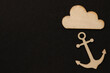 Wooden symbols, blocks on the black background anchor and cloud