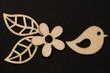 Wooden symbols, blocks on the black background fower, bird and leaves