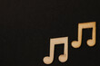 Wooden symbols, blocks on the black background music notes