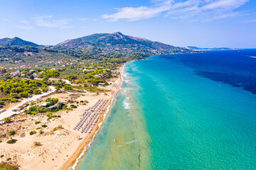 Top view aerial drone photo of Banana beach with beautiful turquoise water, sea waves and straw umbrellas. Vacation travel background. Ionian sea, Zakynthos Island, Greece