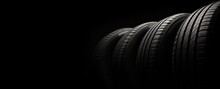 New Car Tires. Group Of Road Wheels On Dark Background. Summer Tires With Asymmetric Tread Design. Driving Car Concept.