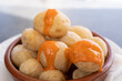 Papas arrugadas in clay plate and spicy mojo sauce on top. Traditional wrinkled potatoes snack food from Gran Canaria island, Spain
