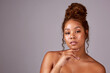 © Chanelle M/peopleimages.com - We dont always need makeup to be beautiful. Studio shot of a beautiful young woman posing against a pink background.