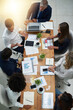 © Lucinda De Bruin/peopleimages.com - On a mission to realise their vision. High angle shot of a group of businesspeople having a meeting in an office.